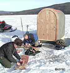 Cleaning pike on the ice after a successful day Photo by Fronty Parker