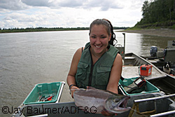 Kuskokwim Native Association KNA high school intern Amanda Goods holds a radiotagged sockeye