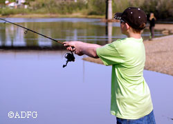 A youth camper casts for Arctic grayling during one of several fishing excursions included with each weeklong session of the Alaska Conservation Camp program Part of camp each week involves fisheries biologists and educators teaching fishing skills