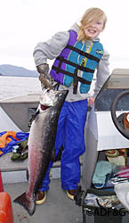 Eleven year old Emily Wood hoisting her recently landed king salmon while fishing with her father near Caamano Point near Ketchikan Photo courtesy of Mike Wood