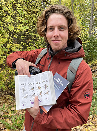 Miles Underwood highlights some birds in his guide while birding by Westchester Lagoon Photo by the author