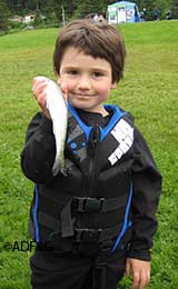A happy young Juneau angler at family Fishing Day at twin Lakes in 2012