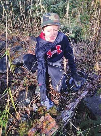 Eli Mank 10 years old reacts to the smell of the scent lure being used on hair boards on Prince of Wales Island Courtesy of the Mank family