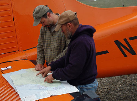 Caribou biologist Jim Dau now retired and biologist and pilot Tom Seaton plan a flight with the department39s beaver to survey the Western Arctic Caribou Herd Photo by Geoff Carroll