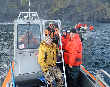 Skiff captain Tom Gage Michelle Oakley Justin Jenniges Kimberlee Beckmen and Michael Rehberg after a particularly wet departure from Marmot Island