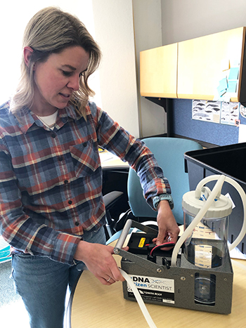 Christi Bubac explains how environmental DNA is filtered from seawater and saved Photo by Riley Woodford