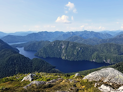 Figure 2. &mdash; Hugh Smith Lake is a long, narrow lake flanked by high fjord walls.