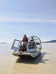 Figure 4. &mdash; An ADF&G technician waits aboard the airboat.