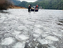 Figure 5. &mdash; Hugh Smith Lake, two crew members are surrounded by floating ice in the fall.